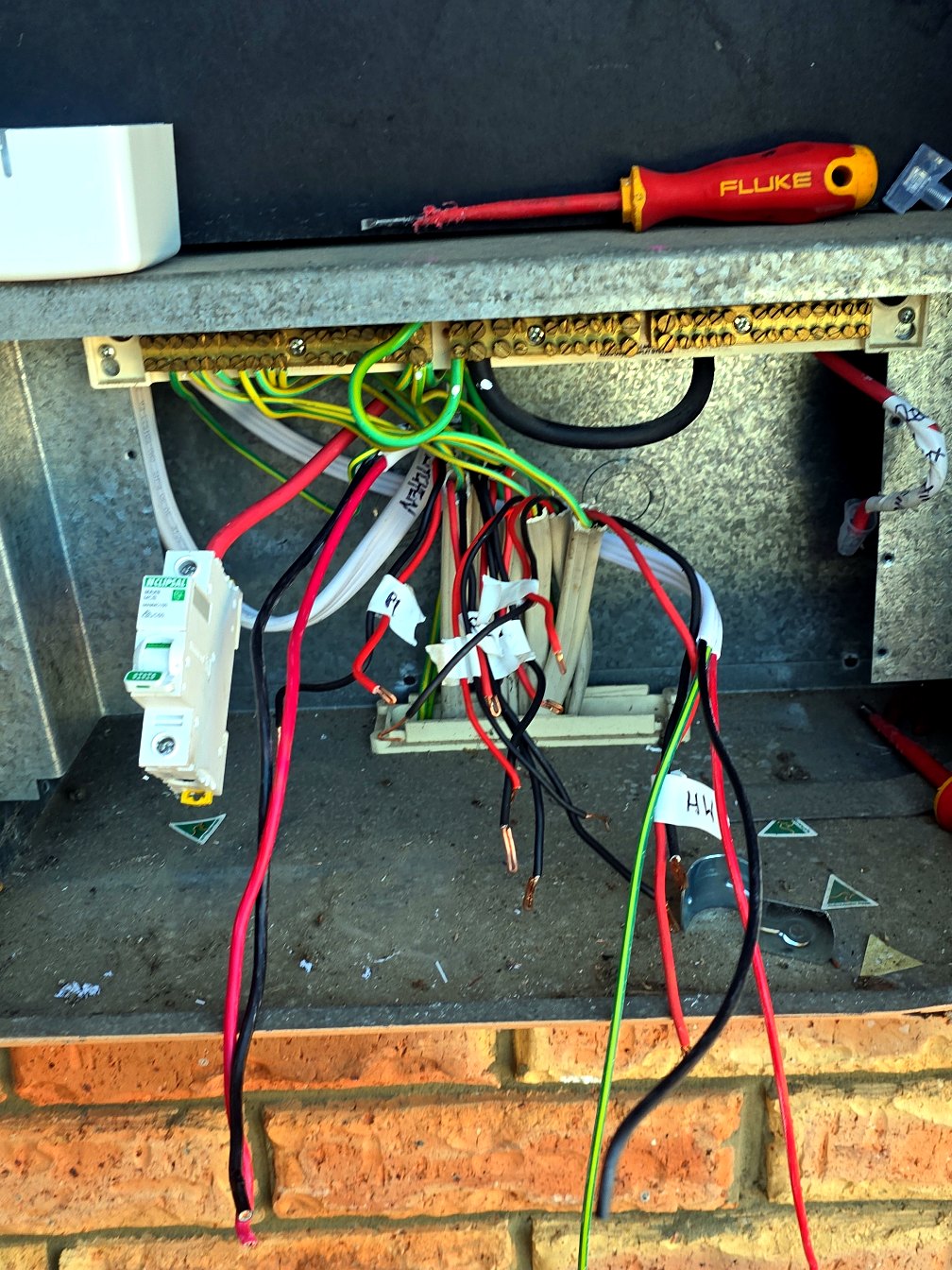 Switchboard mid-upgrade with wiring and new components being installed